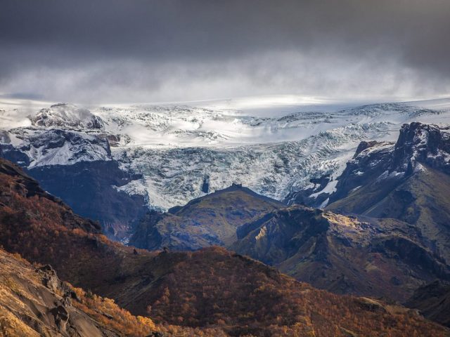 Panoramic view of snowy peaks in Thórsmörk under a cloudy sky.
